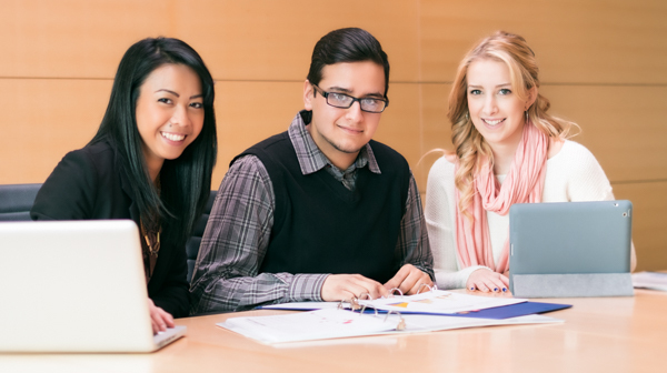 Three academic advisors smile