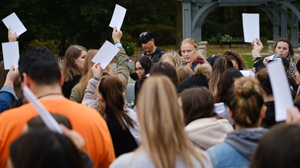 Students hold up cards as part of the Blanket Exercise at Orange Shirt Day