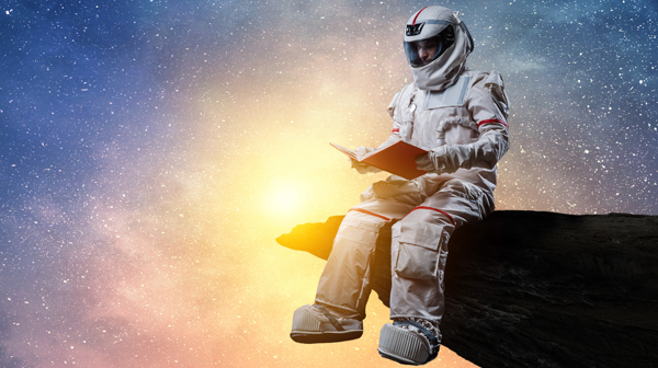An astronaut reading a book