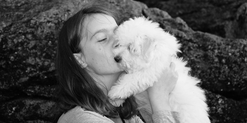 Woman kissing dog