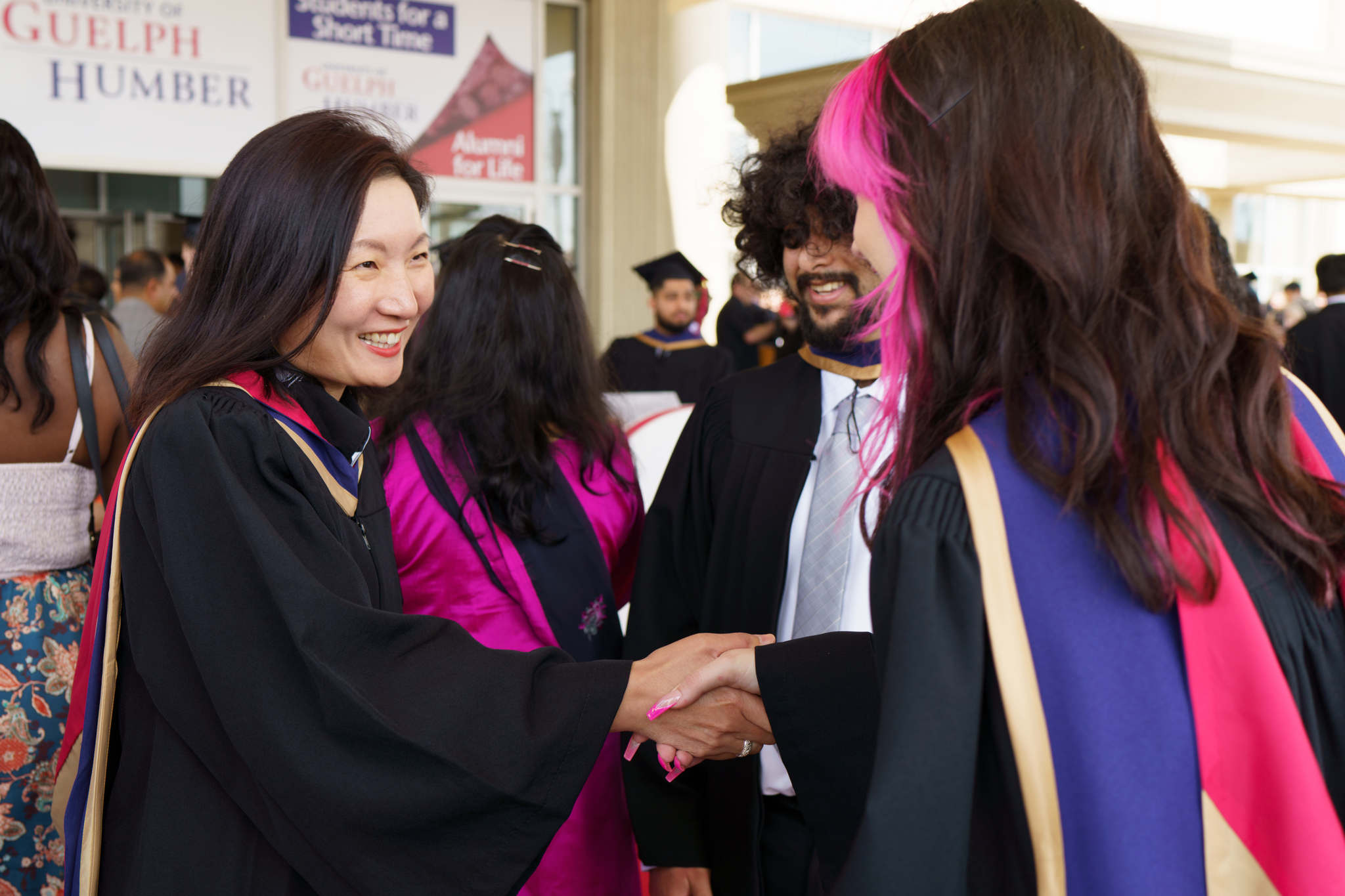Professor shaking student's hand at convocation