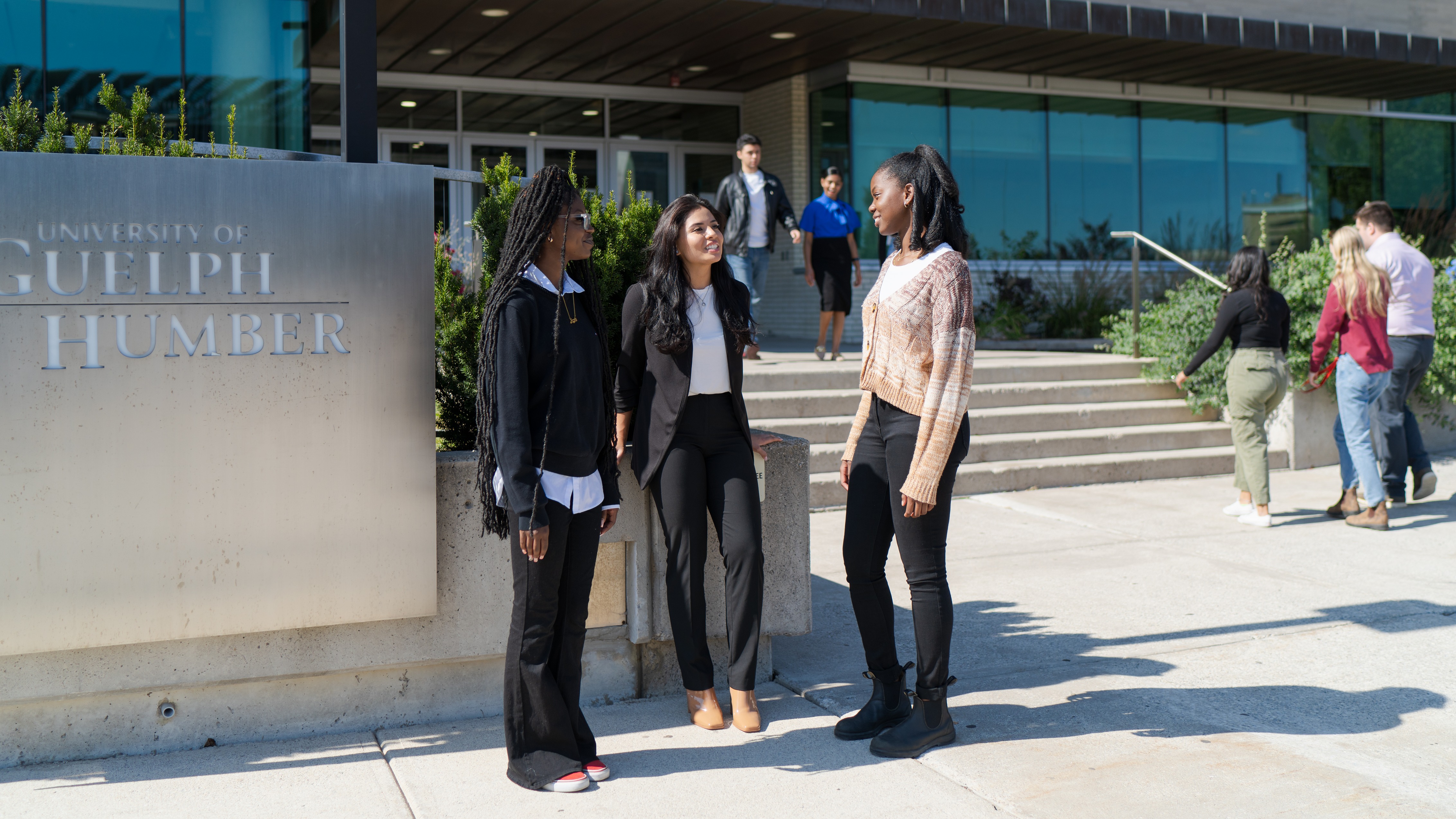 Group of students standing outside beside sign that says University of Guelph-Humber