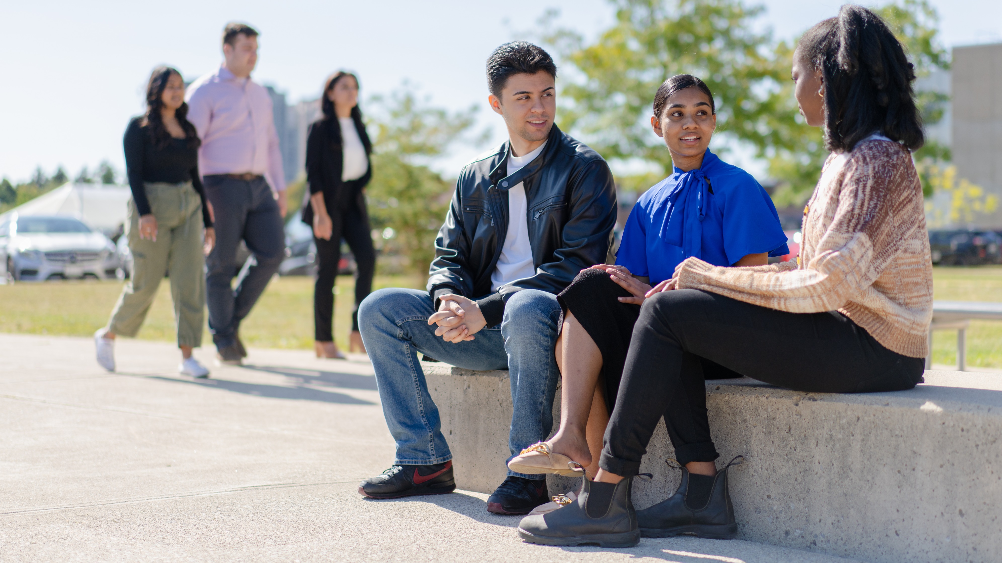 Students sitting together outside the UofGH building