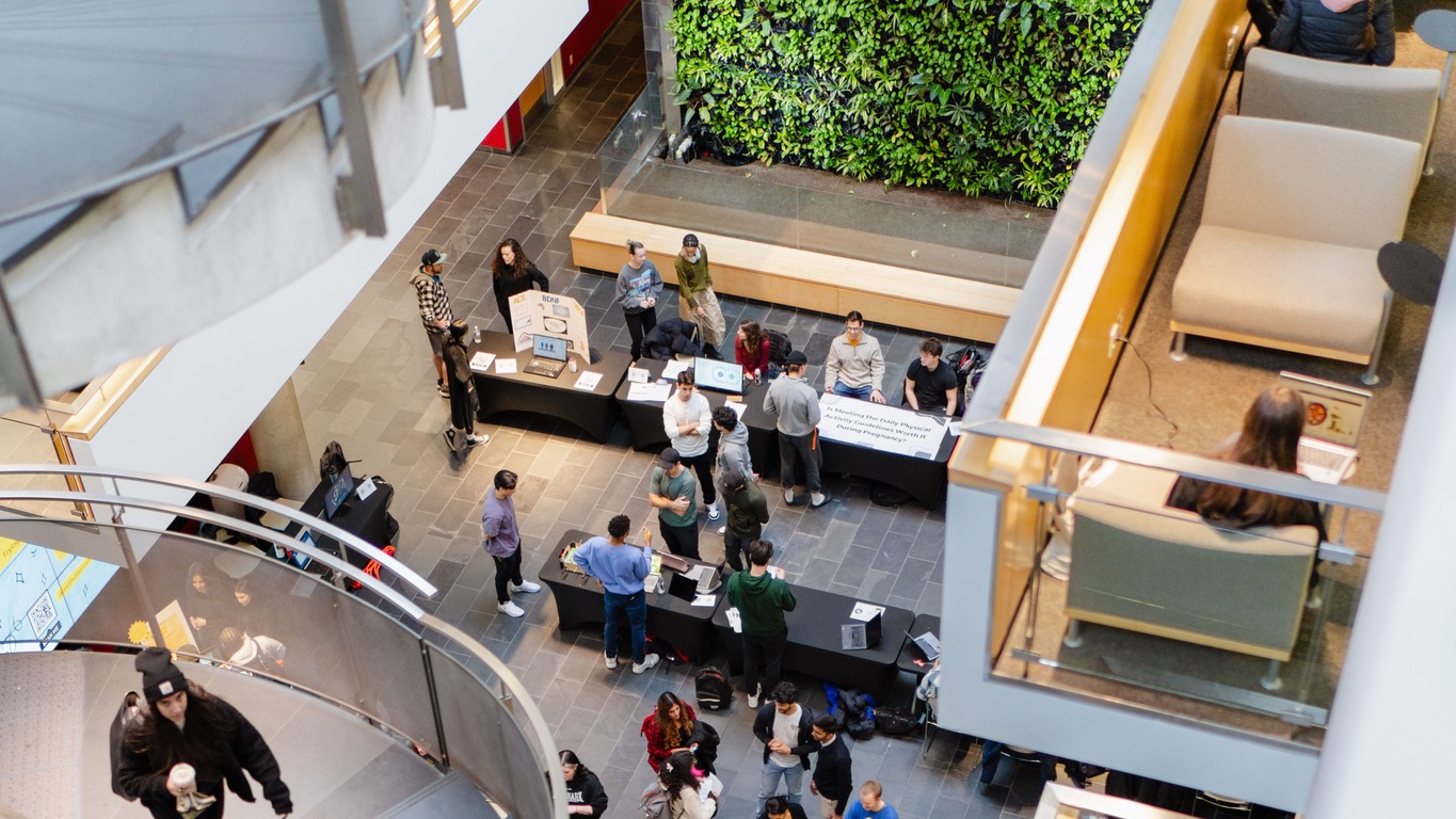 View from above showing spiral stairs and people mingling at event below