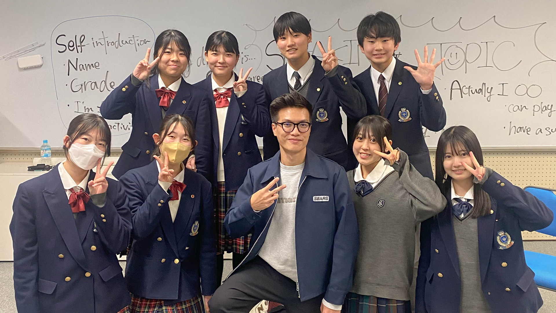 A group of Japanese high school students with UofGH student