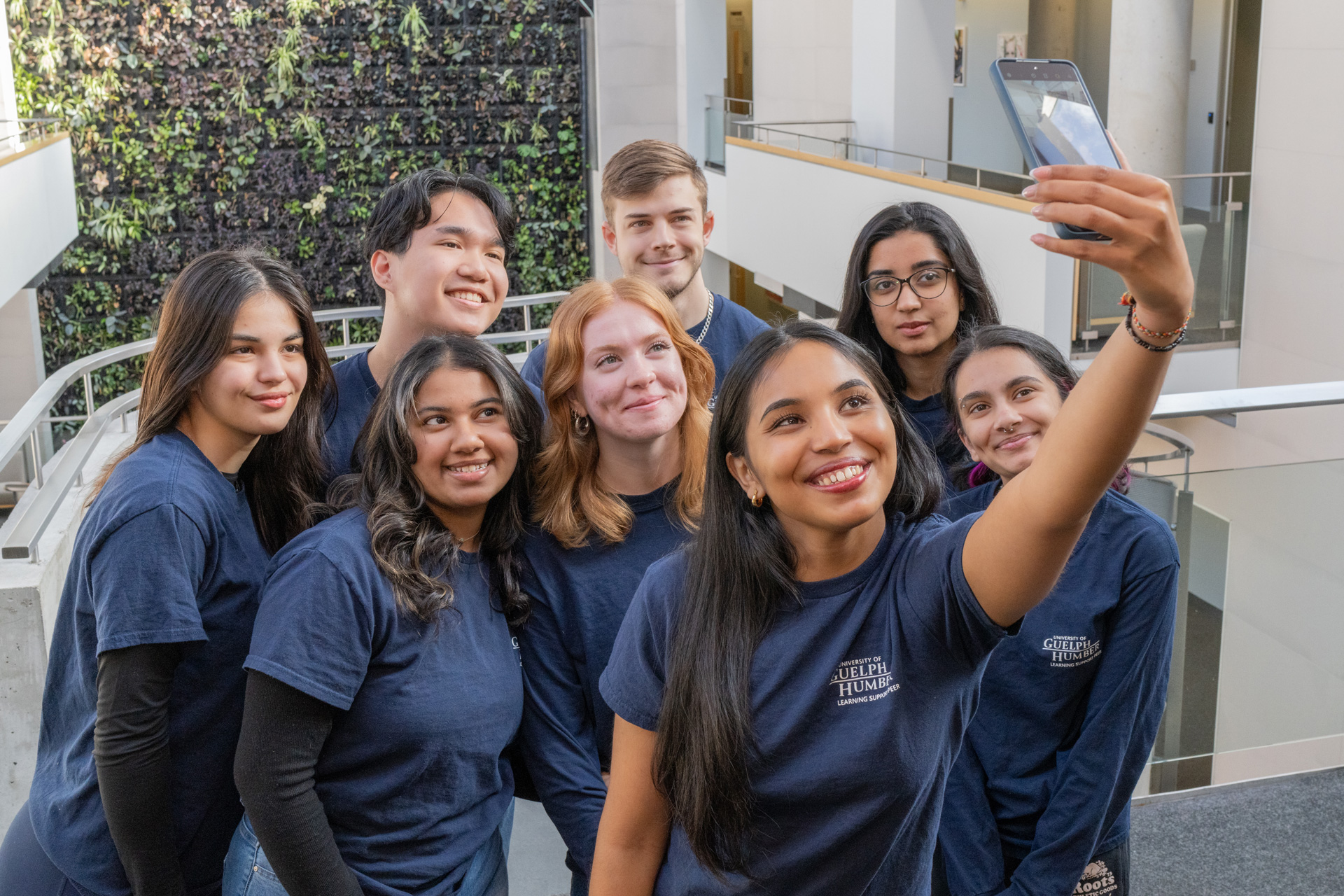 Eight students gathered together taking a selfie