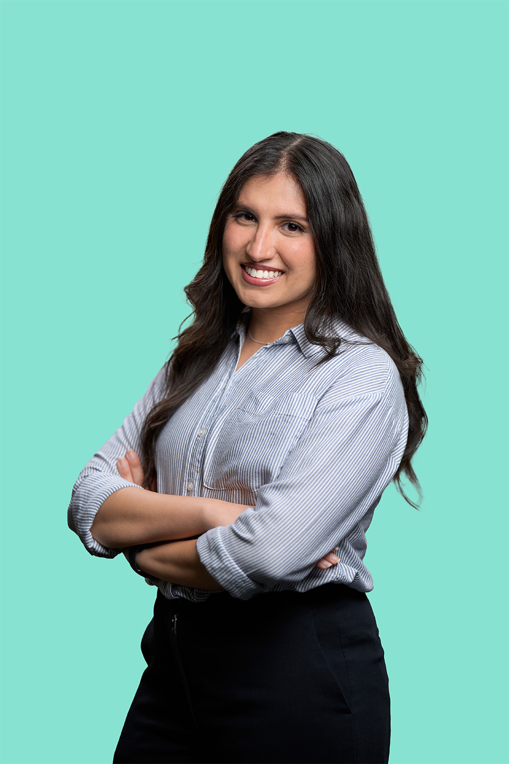 Female with long brown hair wearing business attire