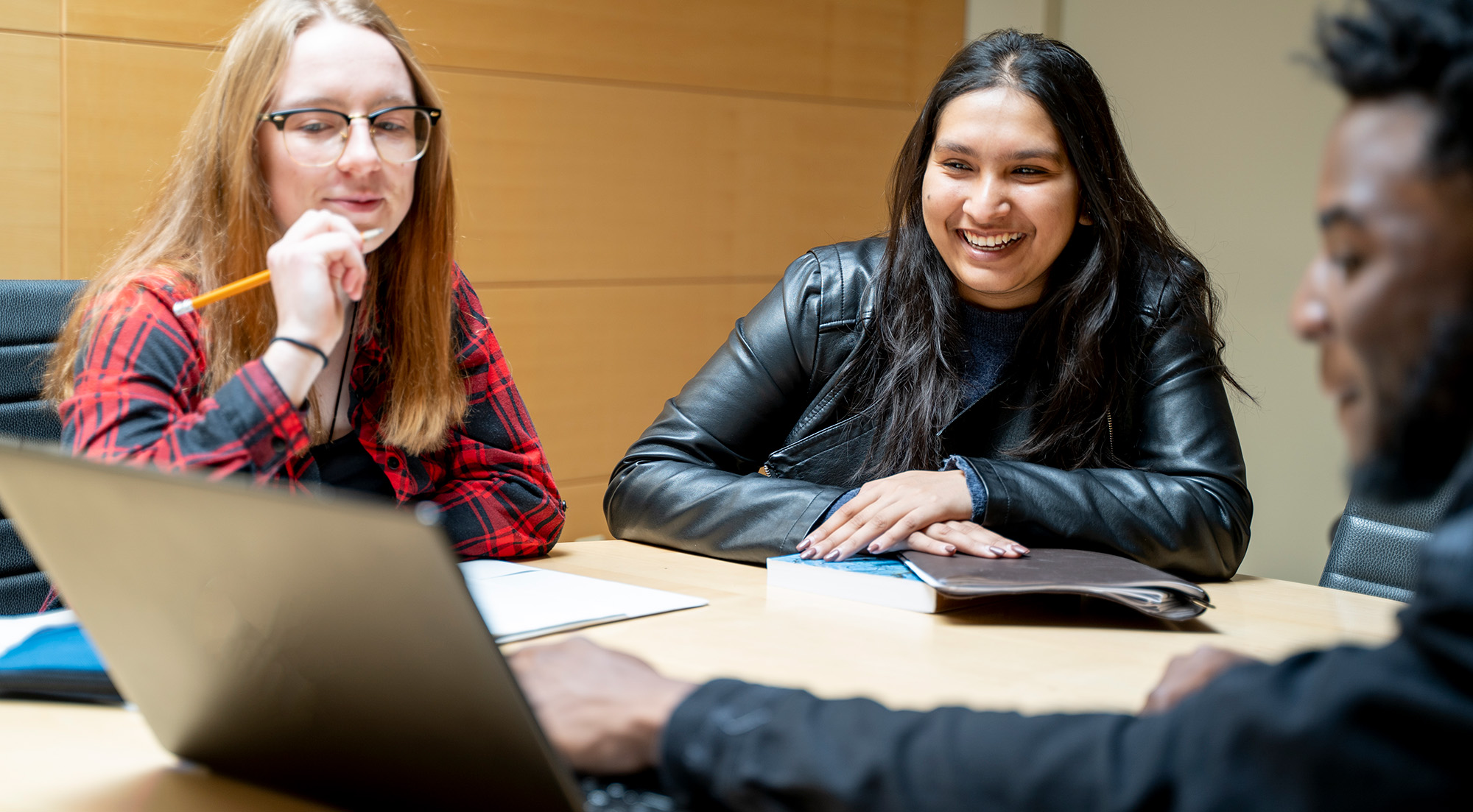 Tuition & Financial Support Three students looking at laptop
