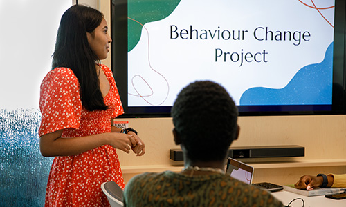 female student presenting a behaviour change project to male student