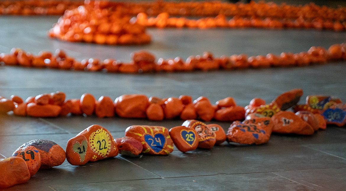 Every Child Matters Art Installation hundreds of painted orange rocks forming a circle