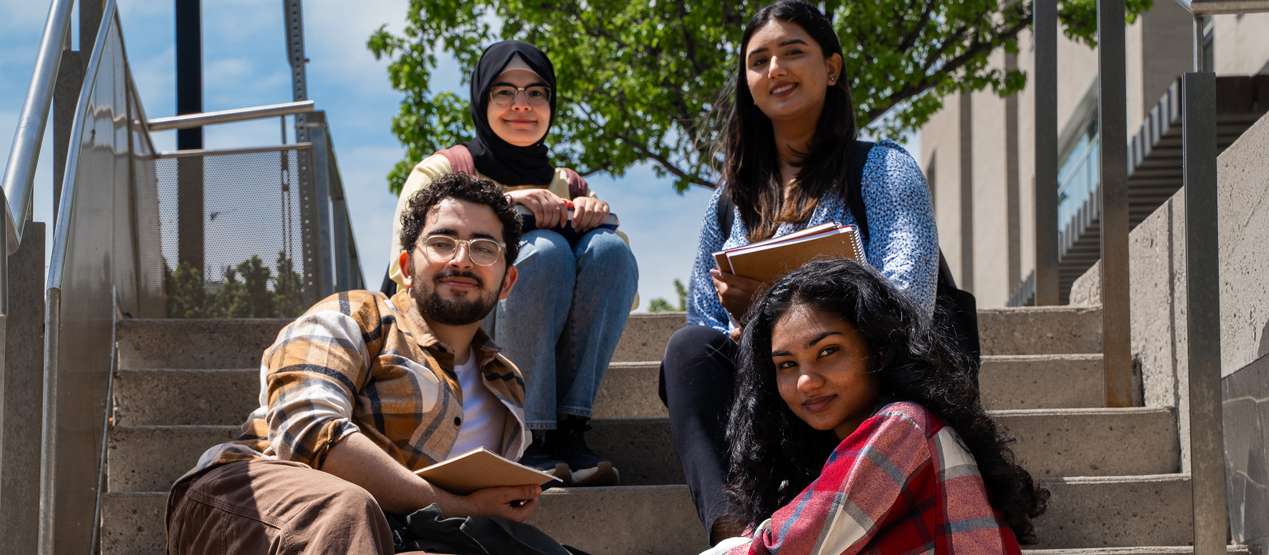Four students on stairs
