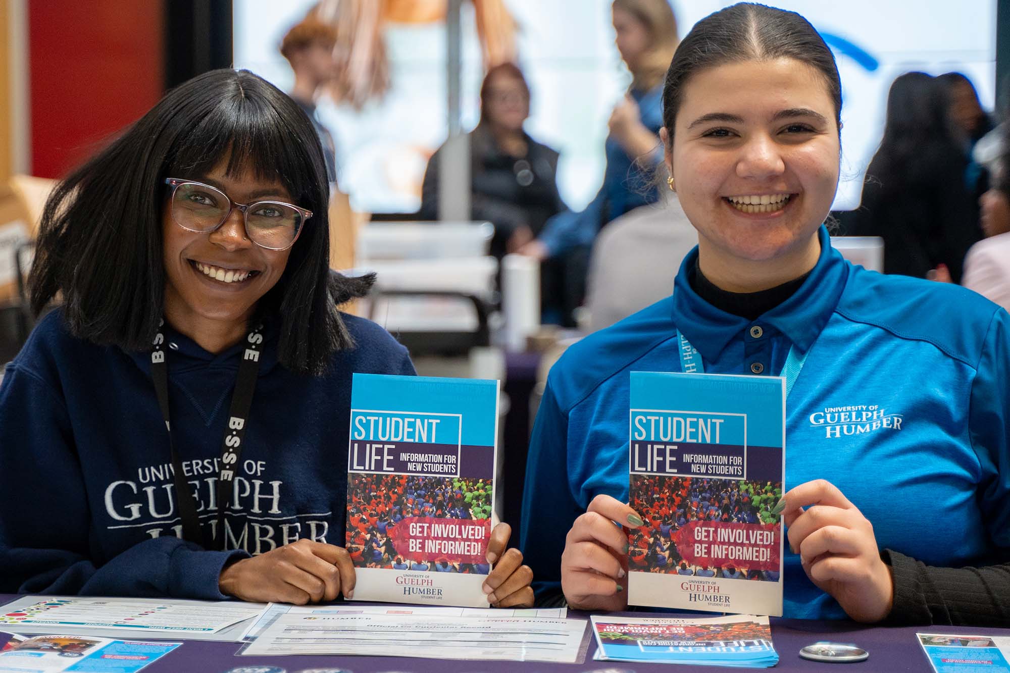 two women holding pamphlets