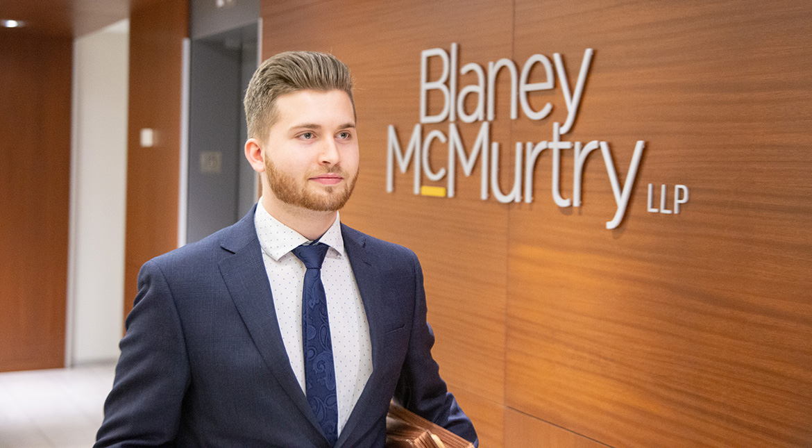 Law firm placement man with blond hair in front of Blaney McMurtry LLP