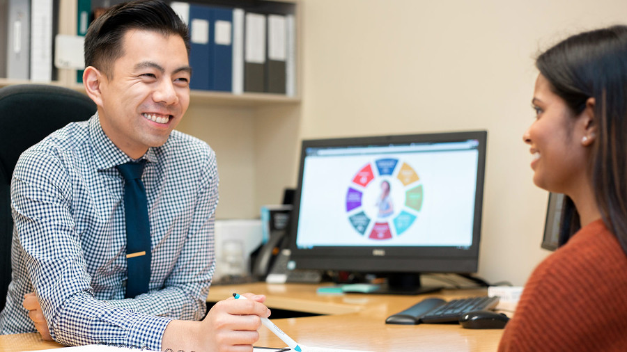 Advisor and student talking in office
