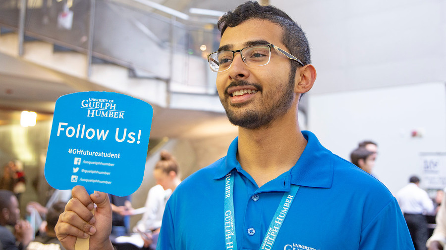 Tour guide holding a 'Follow Us' sign