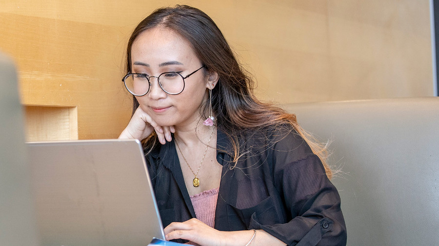 Student looking at a laptop computer