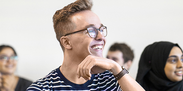 Close-up of a student smiling in a classroom