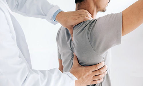 Closeup of hands on patient's shoulder and back
