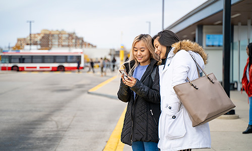 Two women at bus stop