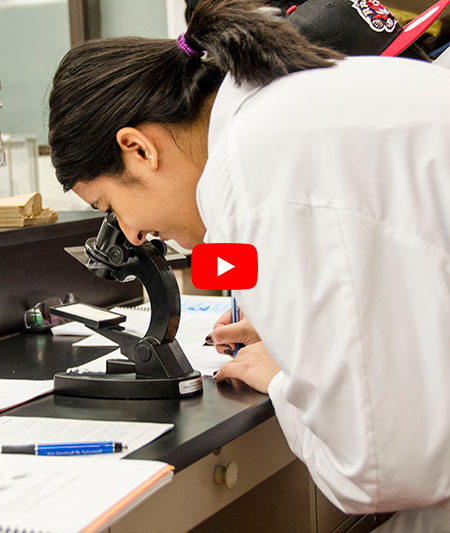 Student looking at microscope youtube play button