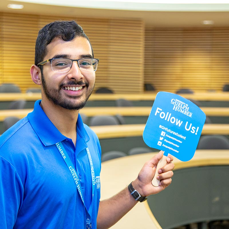 Tour guide holding a 'Follow Us' sign