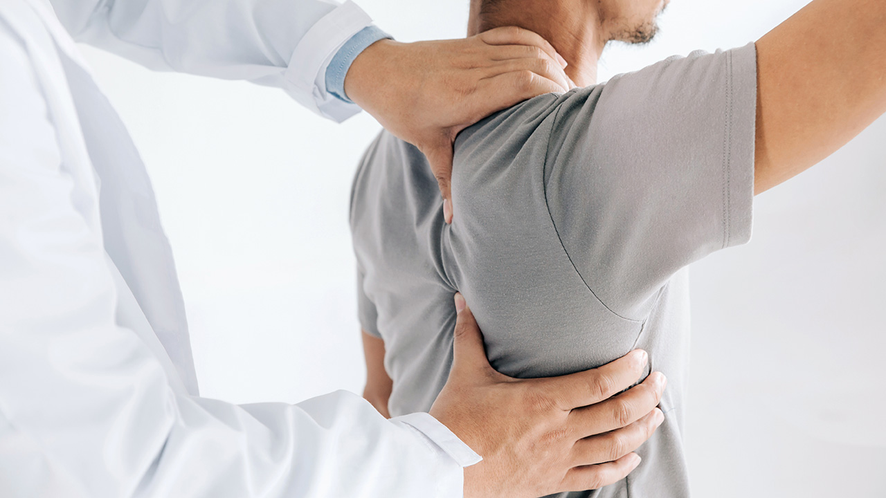 Closeup of hands on patient's shoulder and back