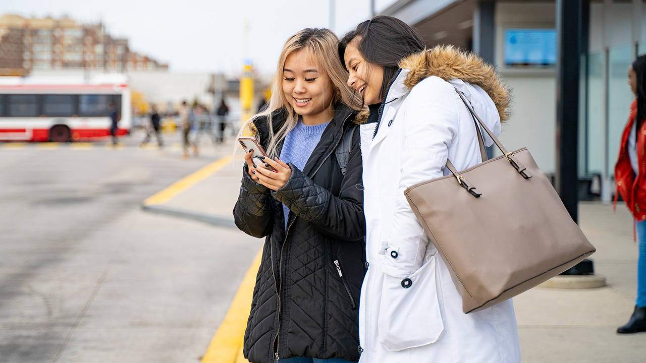 Two women at bus stop