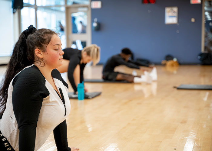 Students stretching in studio