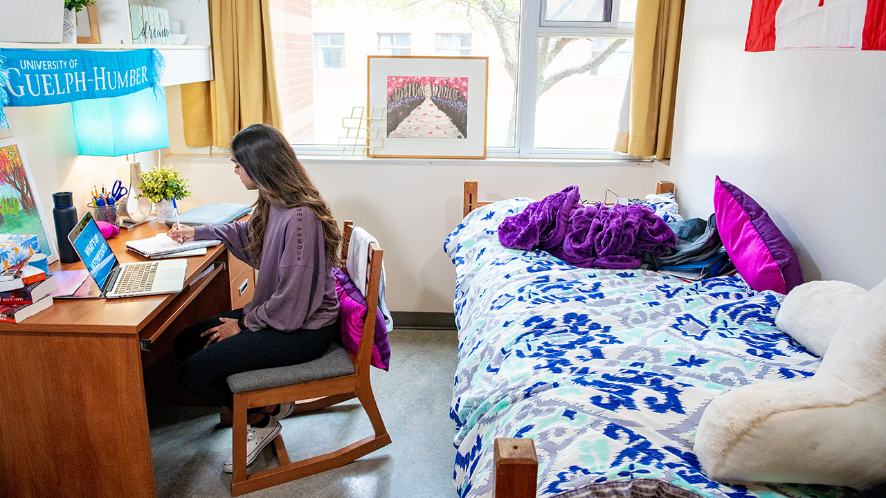 Student working at desk in residence room