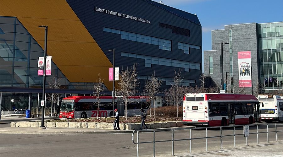Three buses at a bus terminal