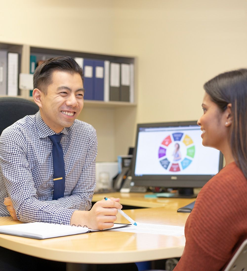 Academic advisor speaking to student