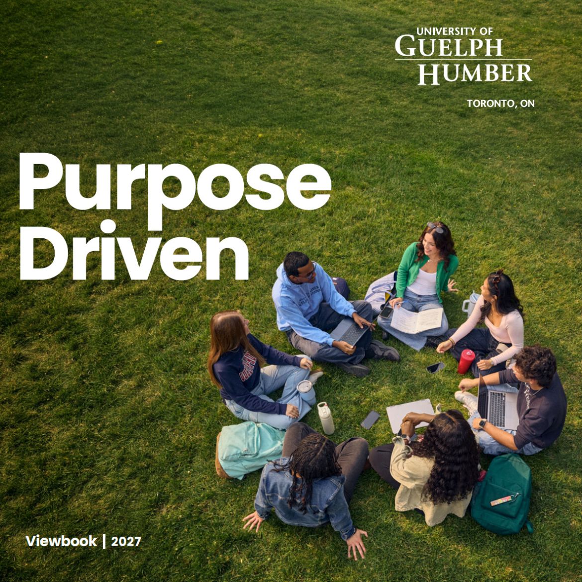 students sitting in a circle on grass