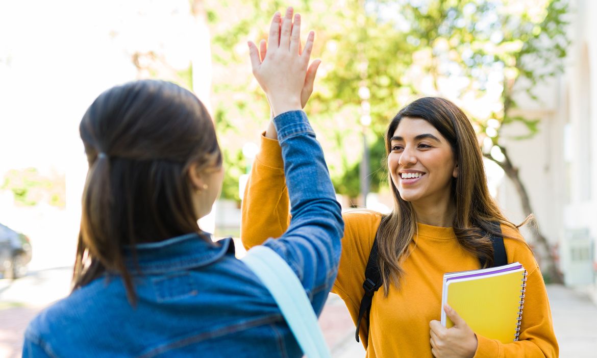 Two students giving each other a high five