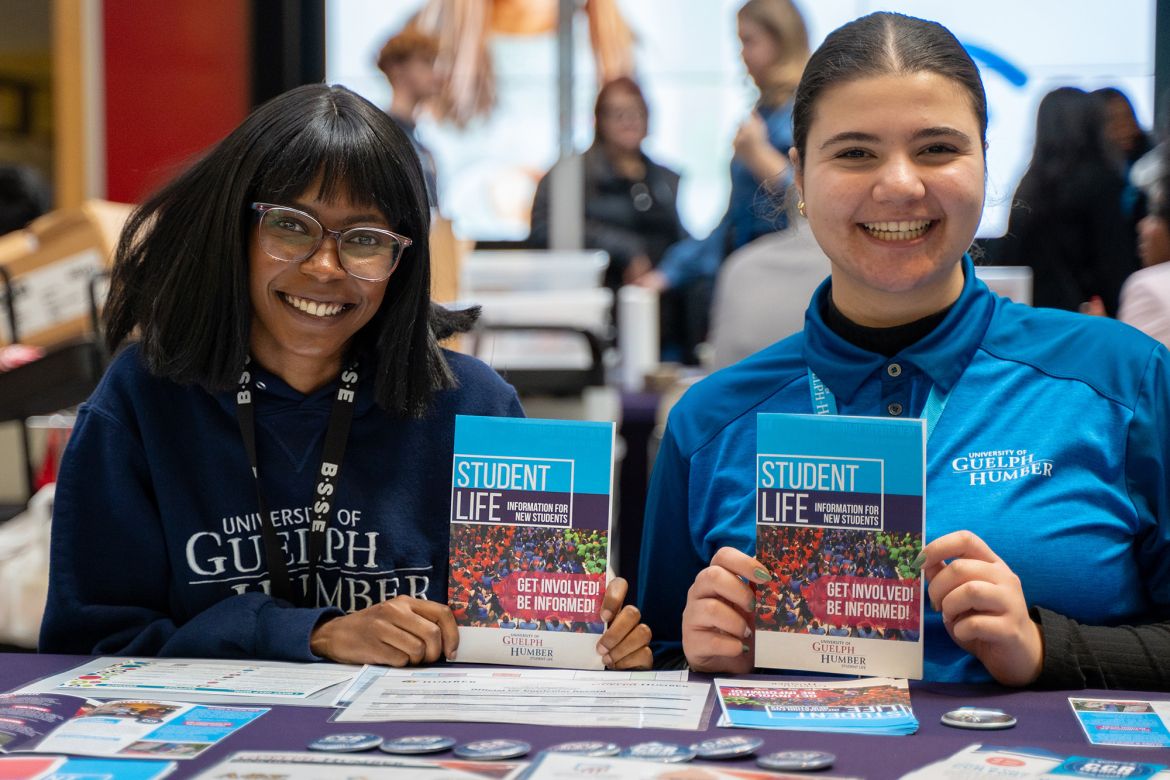two people holding pamphlets