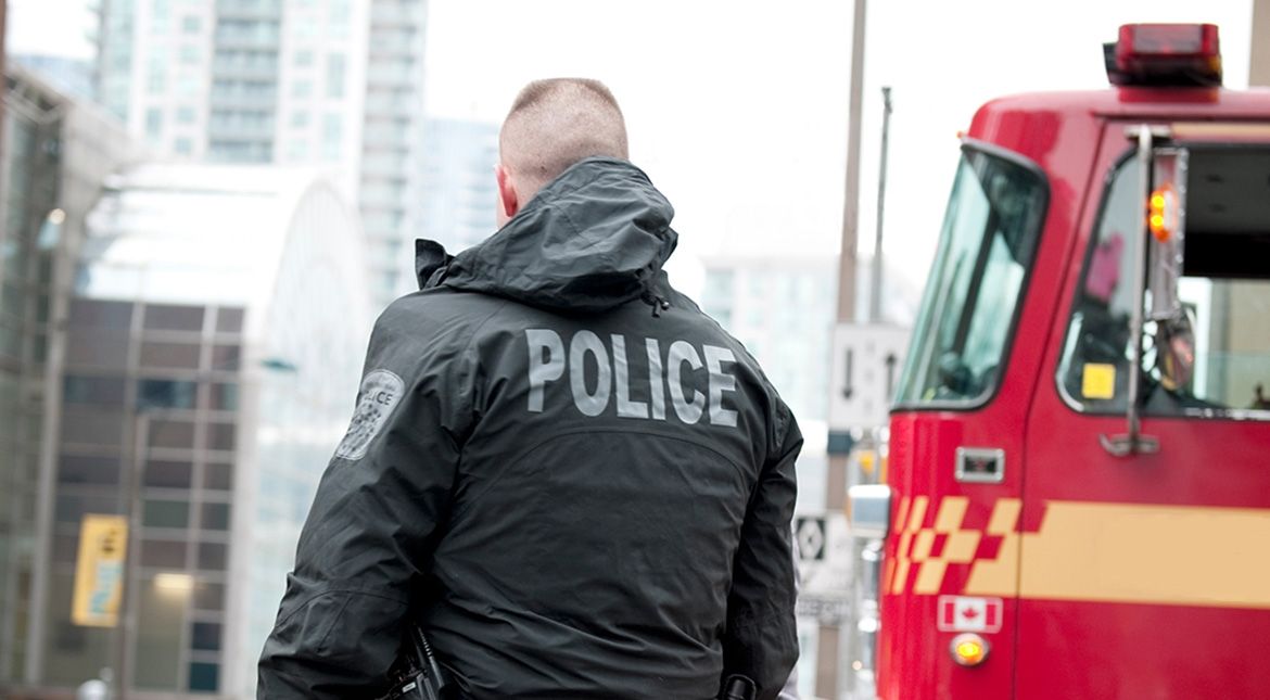 Police officer's back and fire truck in background