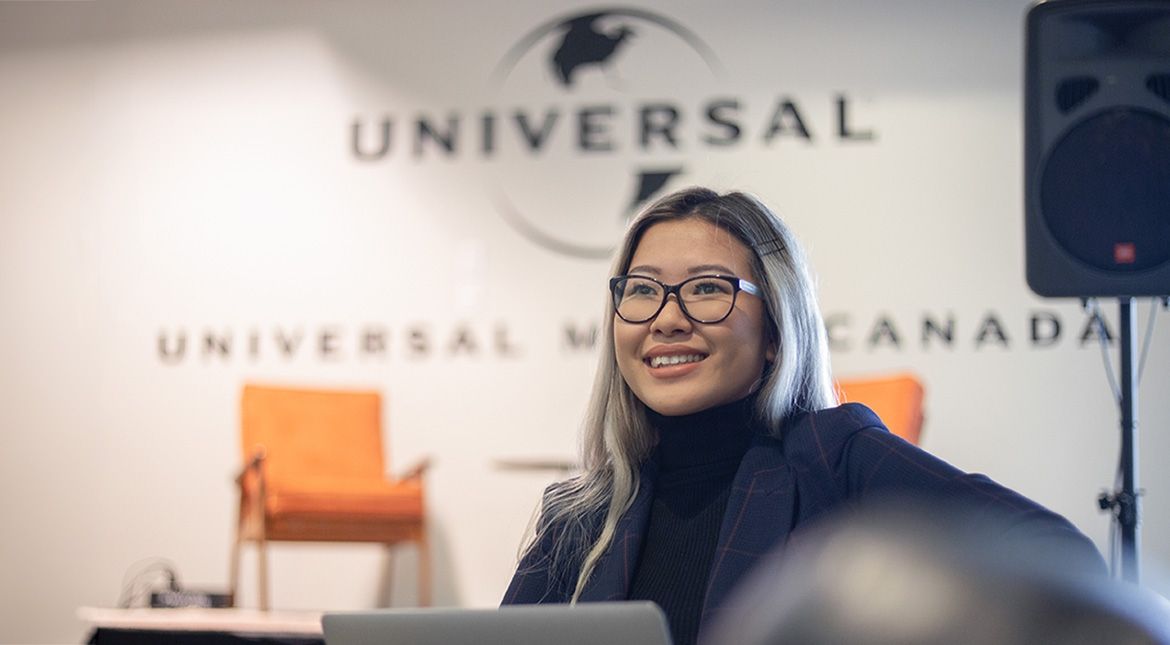 female student in front of universal sign