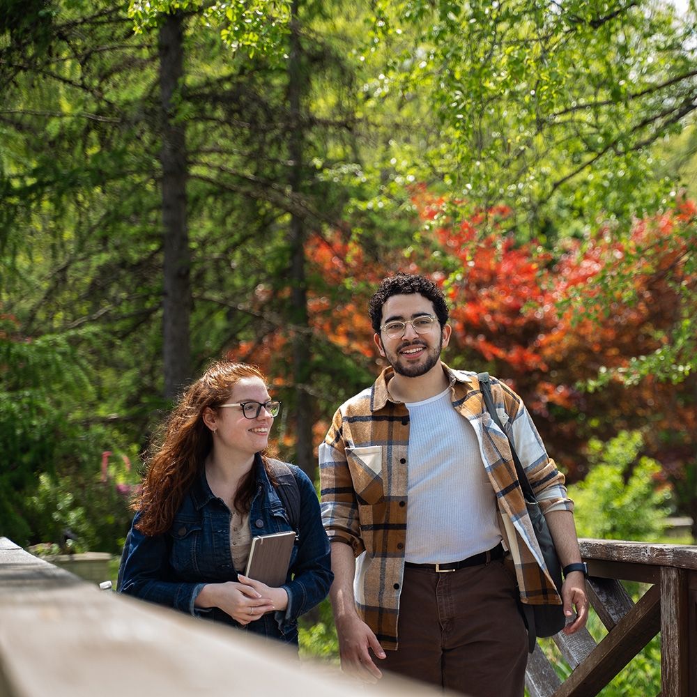 two students walking in the arboretum