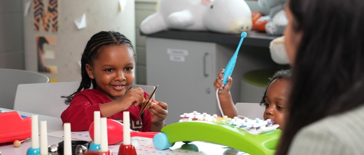 student playing musical instruments with children