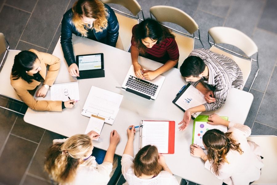 Group of students working at a table bird's eye view from top