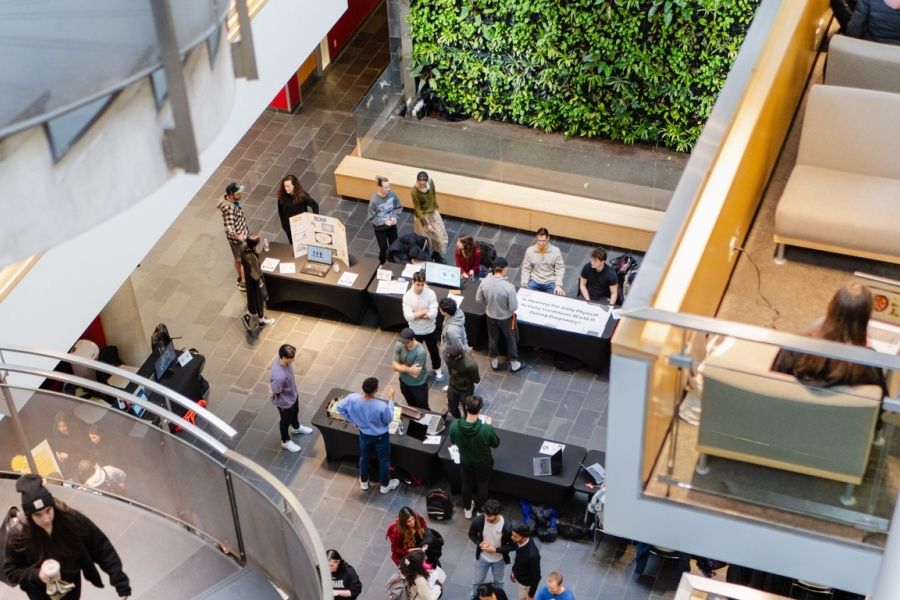 View from above showing spiral stairs and people mingling at event below