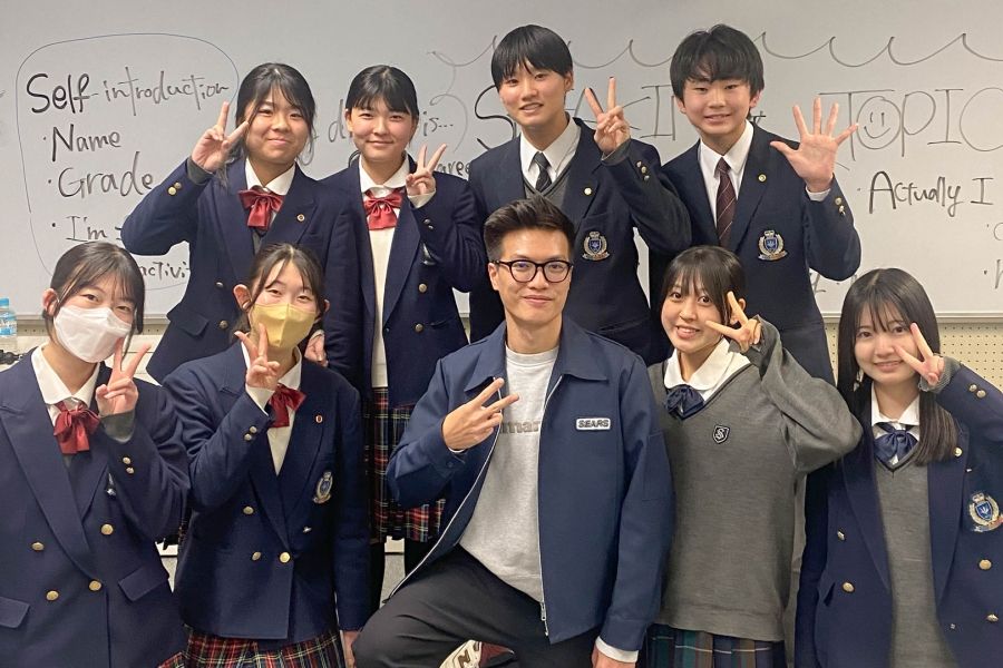 A group of Japanese high school students with UofGH student