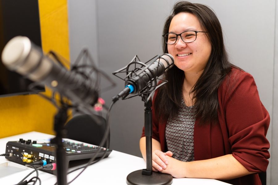 Dr. Victoria Chen in podcast booth with microphone