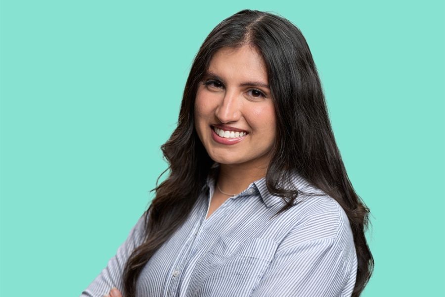 Female with long brown hair wearing business attire