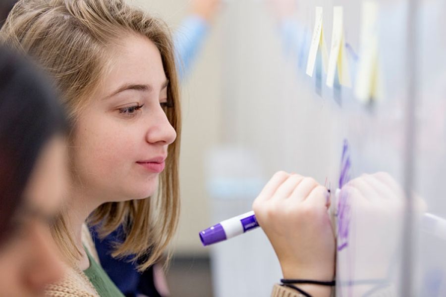 students writing on whiteboard