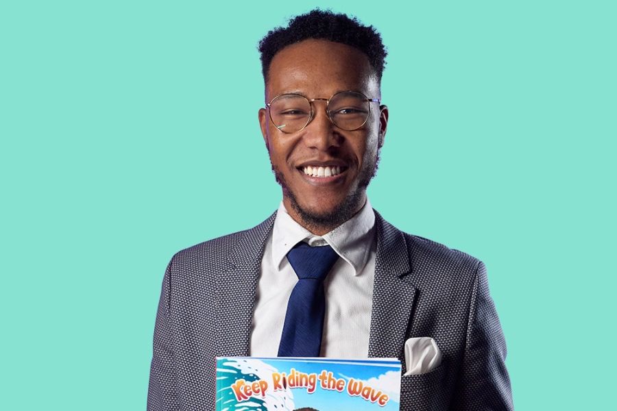 man in suit holding a book