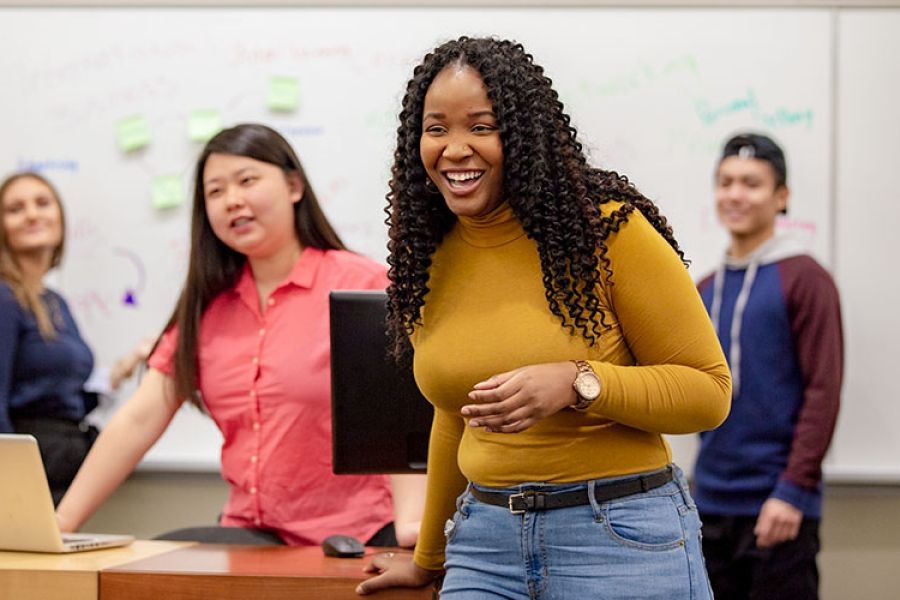 four students presenting to class