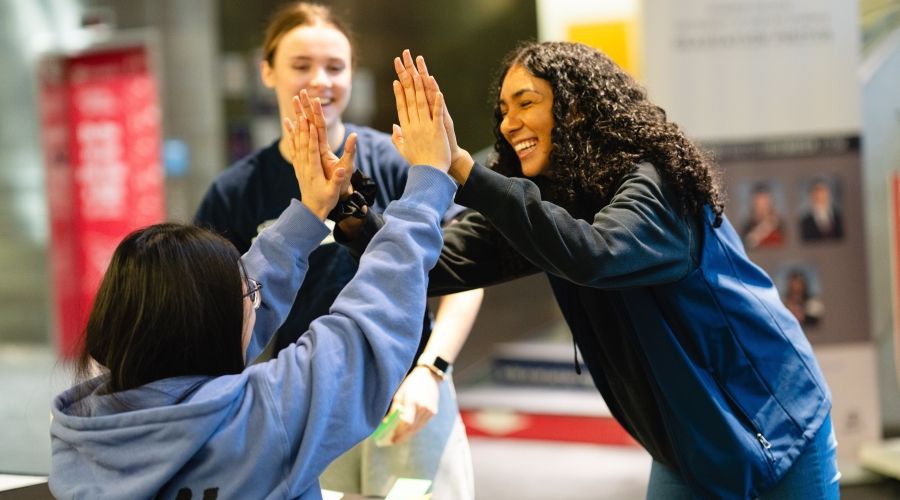 Two students high-fiving