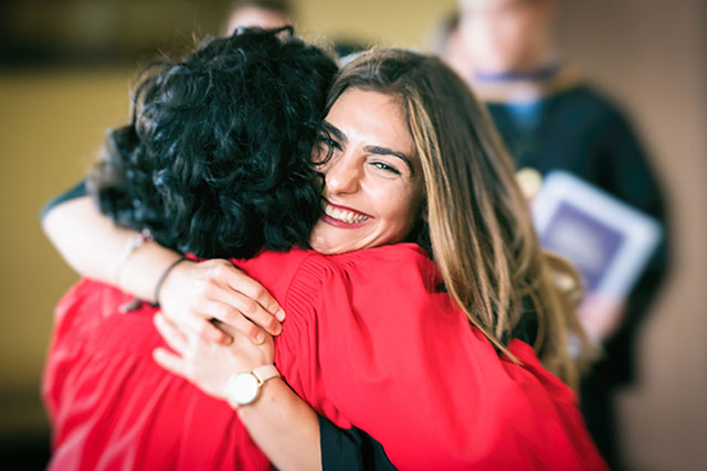 Parisa Khazra hugs a UofGH advisor