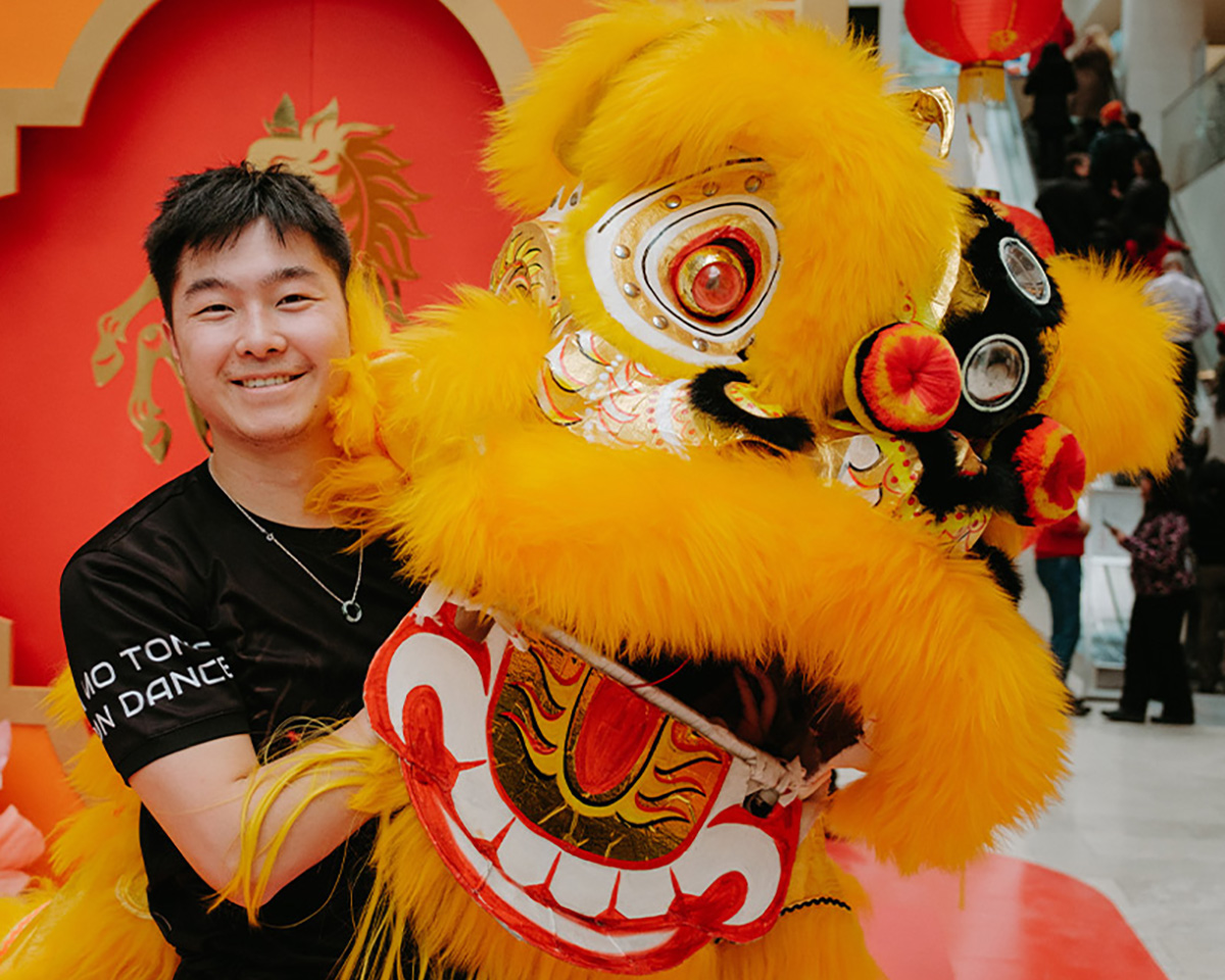 Asian male with giant dragon puppet